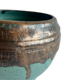 Close-up of a ceramic pot with textured surface and gradient color
