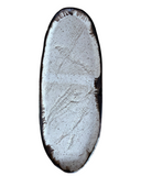 A large oval stoneware serving platter with a bronze accent at the lip and a subtle woven texture, primarily in gray and white tones.