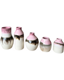 Set of five ceramic vases with pink and black glaze on a white background
