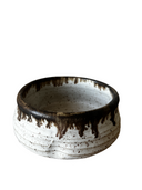 Stack of handcrafted ceramic pinch bowls in black, white, and brown colors