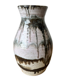 Ceramic vase with black and white glaze pattern on a white background