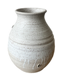 Speckled gray ceramic vase on a white background