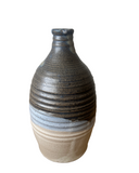 Ceramic vase with textured design on a white background