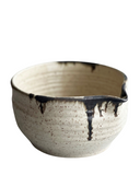 Ceramic bowl with black accents on a white background