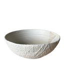 Textured ceramic bowl on a white background