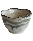 Ceramic bowl with textured surface on a white background