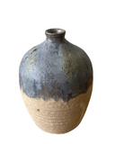Ceramic vase with blue and beige gradient on a white background