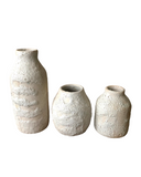Three textured ceramic vases on a white background