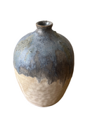 Ceramic vase with blue and beige glaze on a white background